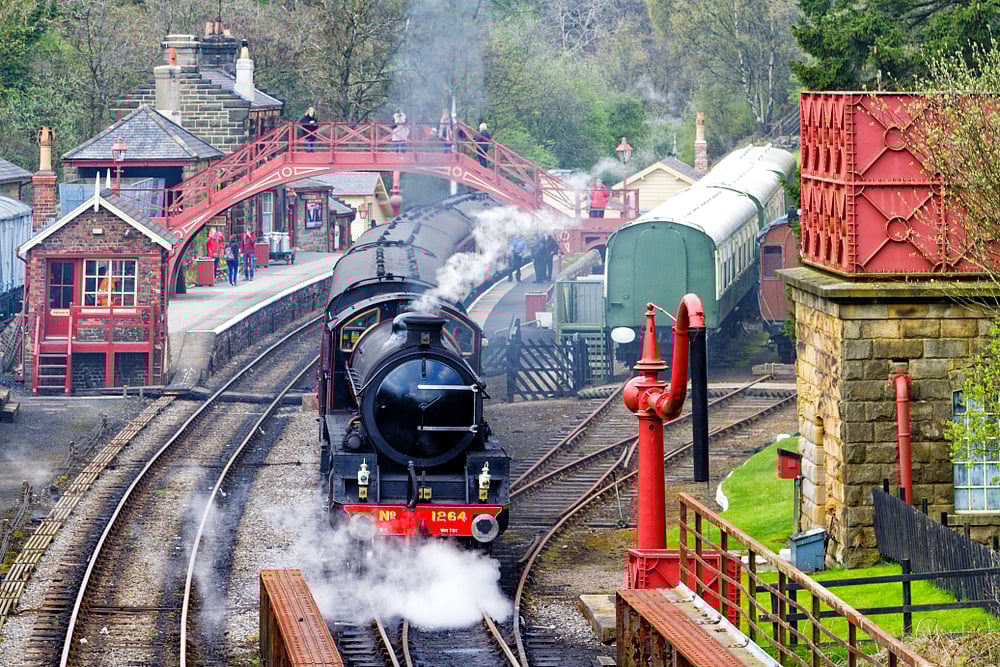 A vintage passenger steam train leaving Goathland Station on the way to Whitby on the North York Moors Railway